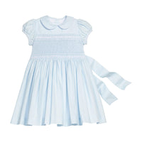 Little English classic smocked emery dress in light blue with white detailing, smocking around chest, tieable in back, for little girl 