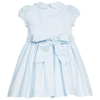 Little English classic smocked emery dress in light blue with white detailing, smocking around chest, tieable in back, for little girl 