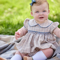 Little English classic children's clothing.  Smocked peter pan bubble in tan and blue Durham windowpane with puff sleeves and blue piping for baby girls