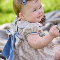 Little English classic children's clothing.  Smocked peter pan bubble in tan and blue Durham windowpane with puff sleeves and blue piping for baby girls