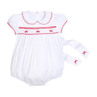 Little English traditional children's clothing, Puff sleeve white peter pan bubble with scalloped collar, red trim, and bow smocking across the chest. Dressy outfit for baby girls for the holiday