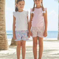 Little English girl's woven short with elastic waist and ruffled hem. Pink floral casual play shorts for Spring.