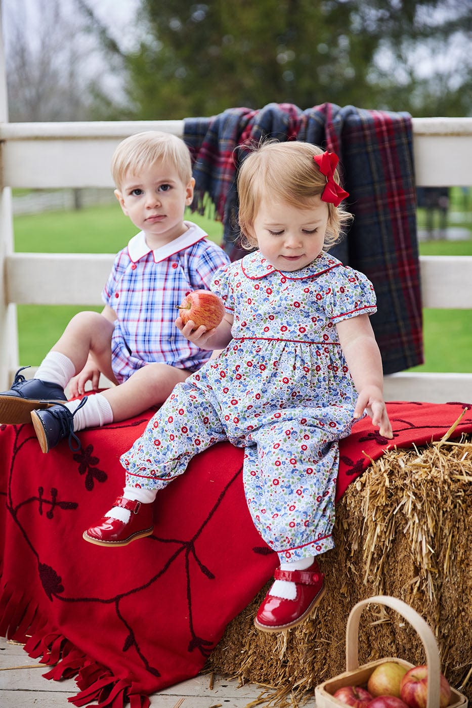 classic baby girl clothes baby girl rommper in blue and red floral print with red piping detail and peter pan collar