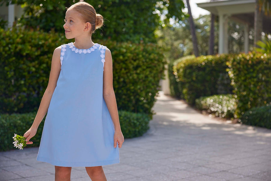 classic childrens clothing girls blue twill shift dress with daisy pattern around hem and arms