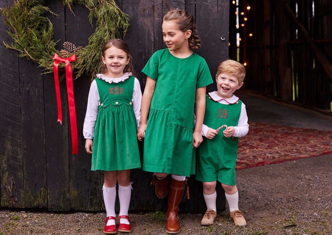 preppy baby boy clothes evergreen corduroy john john with red piping on button tabs on the side and button closures at shoulder