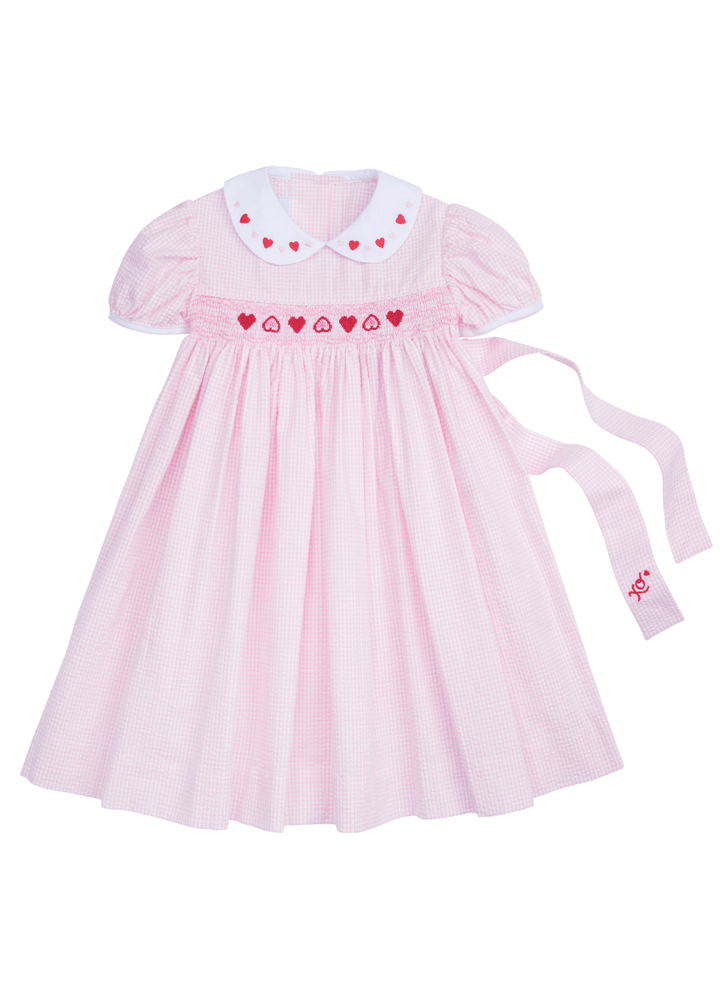 Little English girl's pink seersucker dress with hearts smocking and embroidery at the collar