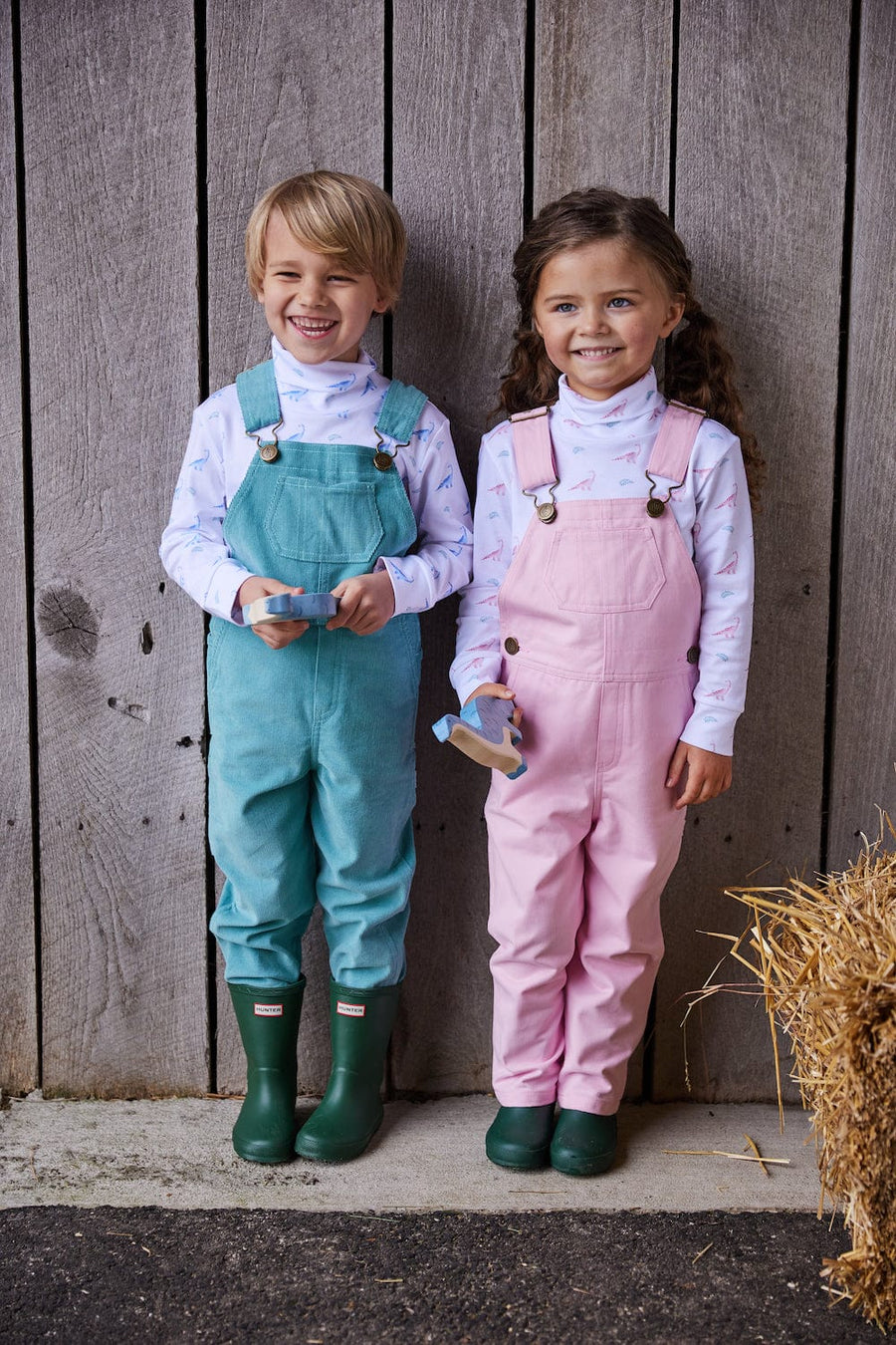 classic childrens clothing overall with brass buttons in a light pink twill